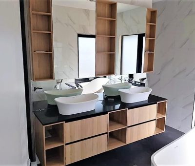 Contemporary bathroom design with double basins and timber vanity featuring open storage.