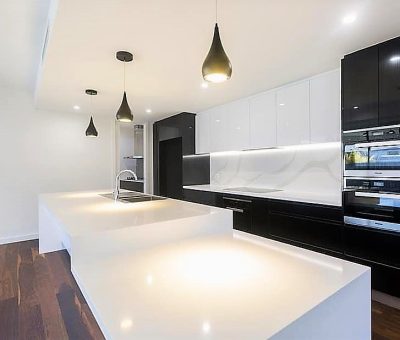 Striking modern kitchen with bold black-and-white contrast and sleek finishes.
