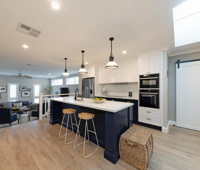 “Contemporary Campbell kitchen with a navy feature island, bright white cabinetry, and open-plan design.”