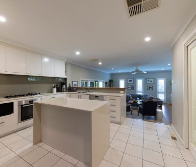 “Campbell kitchen before renovation, featuring tiled floors and a compact island.”