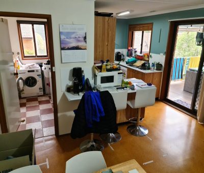 “Kitchen and dining area before renovation, featuring compact layout and dated finishes.”
