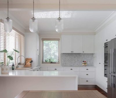 “Modern Mawson kitchen with bright white finishes and elegant marble accents.”