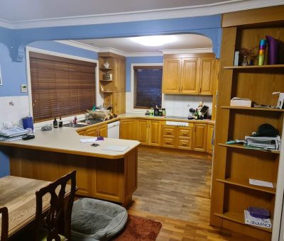 “Mawson kitchen before renovation, featuring timber cabinetry and dated finishes.”
