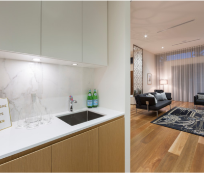 Modern interior with a kitchenette on the left, featuring a marble backsplash and a 
