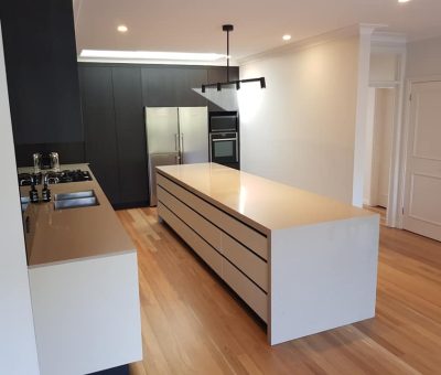 “Contemporary kitchen renovation with a sleek central island and minimalist design.”